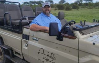 man-sitting-in-a-safari-vehicle